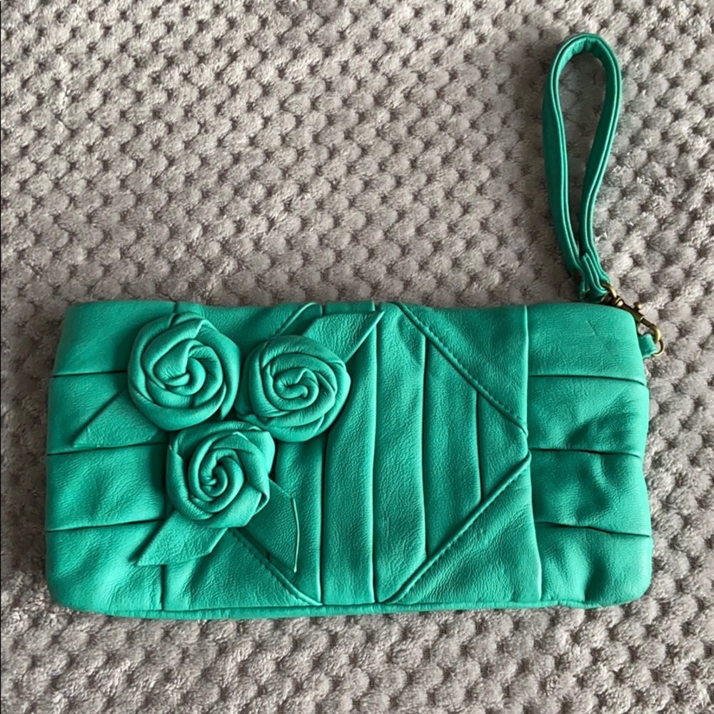Teal wristlet, strap and small zipper inside